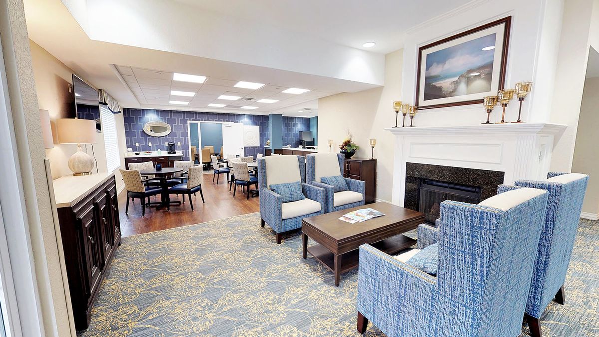 A cozy lobby area with comfortable seating, a fireplace, and elegant interior design.