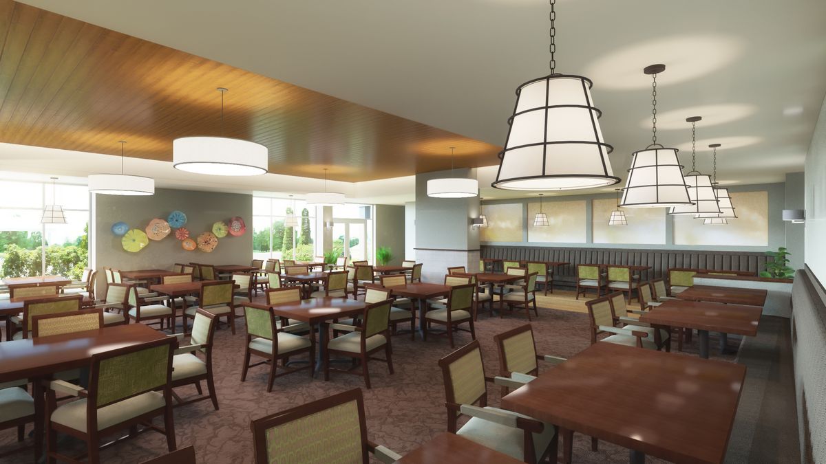 A spacious restaurant dining area with neatly arranged tables and chairs, modern lighting fixtures, and a bright ambiance.