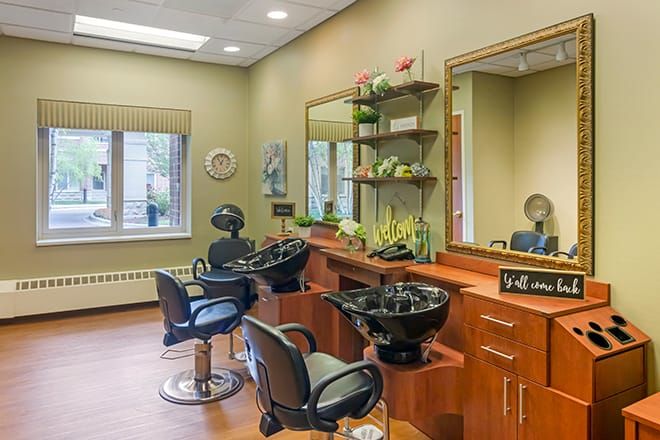 A tidy and well-equipped hair salon with chairs, mirrors, and sinks.