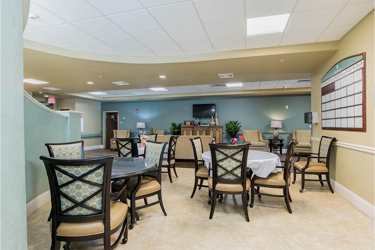 A spacious dining area with multiple tables and chairs, designed for gatherings.