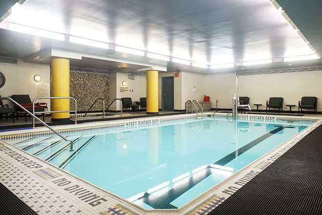 An inviting indoor swimming pool with lounge chairs and modern decor.