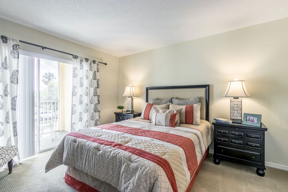 A cozy bedroom with a neatly made bed and stylish decor.