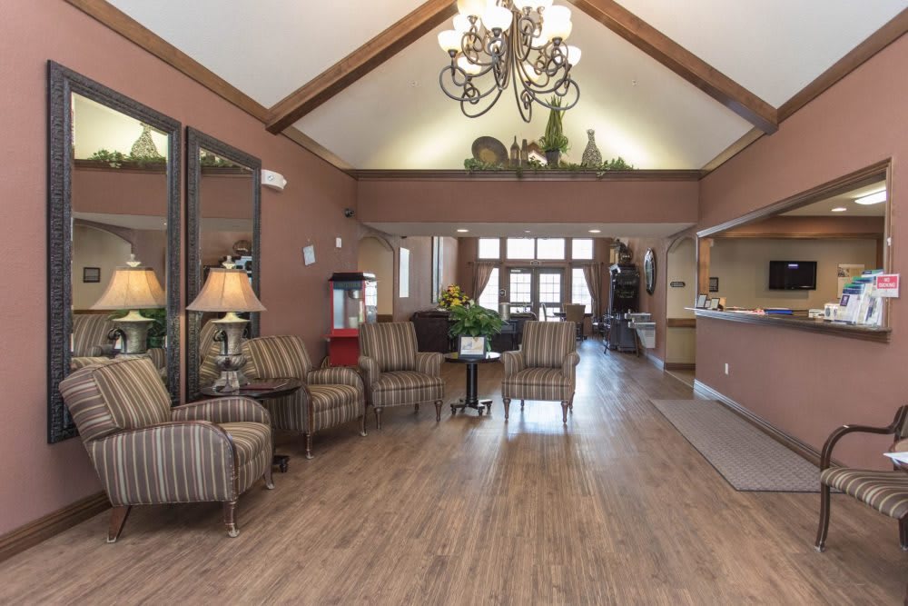A spacious and elegantly designed lobby with comfortable seating, a grand chandelier, and tasteful decor.