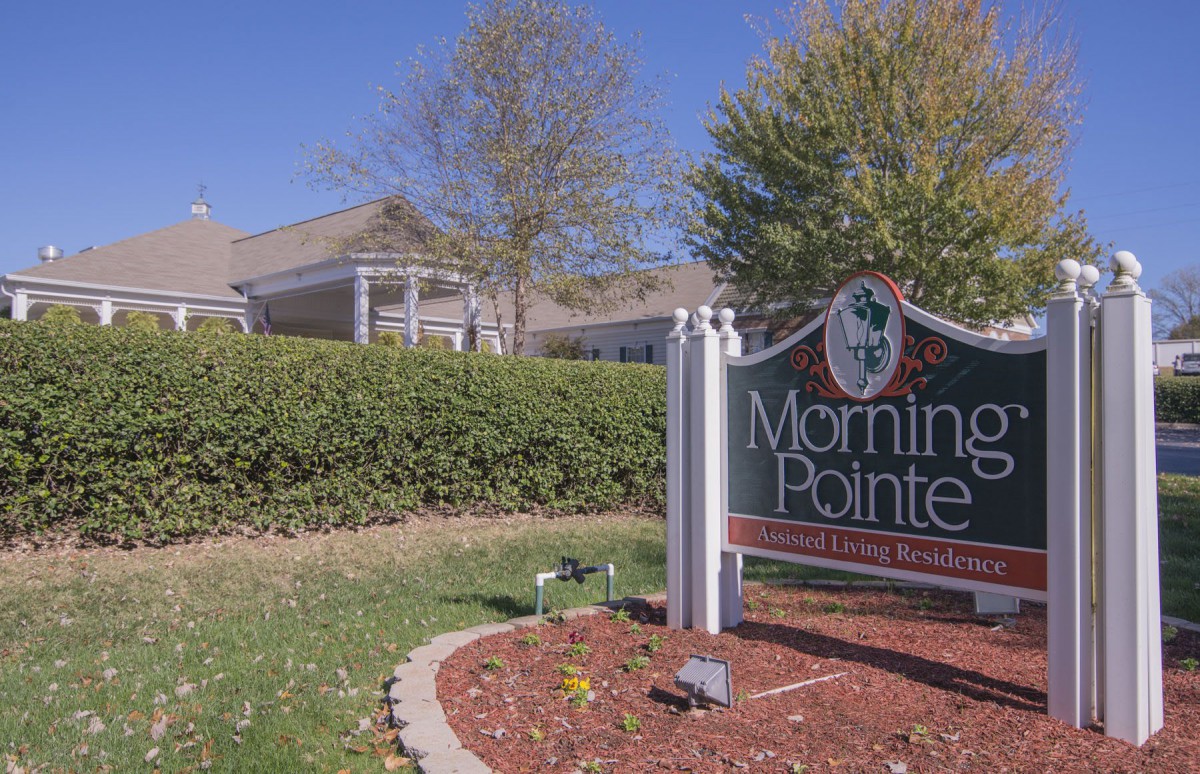 A facility sign reading 'Morning Pointe' surrounded by trees and bushes.