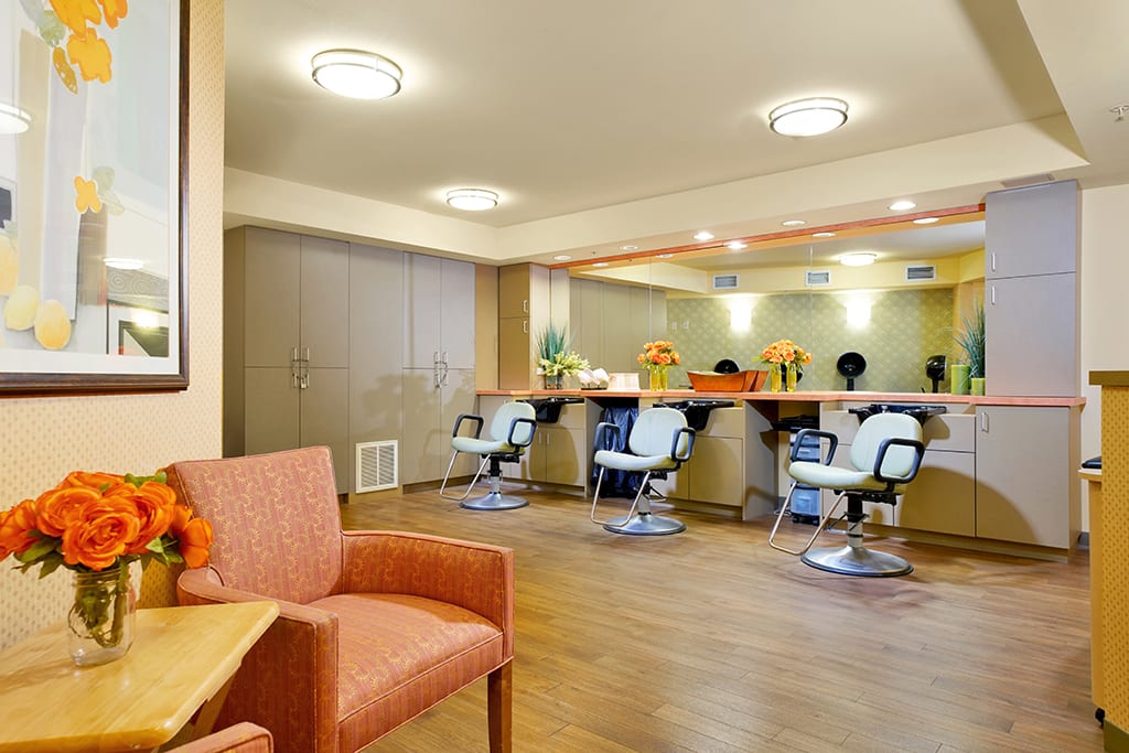 Modern hair salon interior with stylish chairs and mirrors.