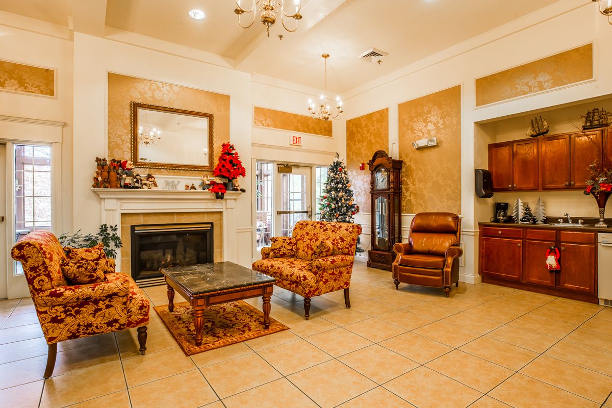 A cozy living room with a fireplace, decorated for Christmas.