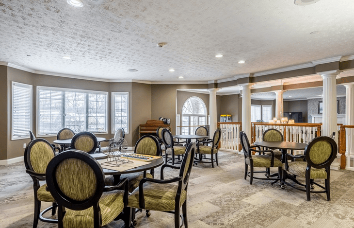 A well-lit dining room with elegantly arranged tables and chairs.