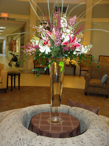 A beautiful floral arrangement in a tall vase, enhancing the elegance of the lobby.