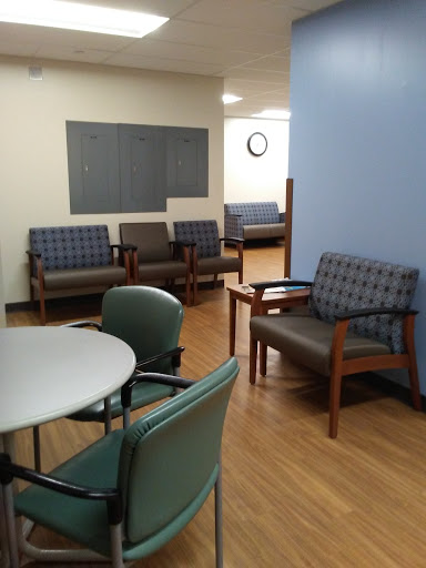 A view of a waiting room with seating and a small table.