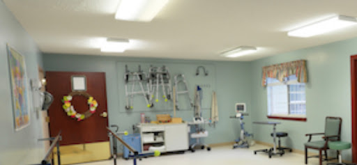 A well-equipped medical treatment room, featuring various therapy tools and a clean, organized environment.