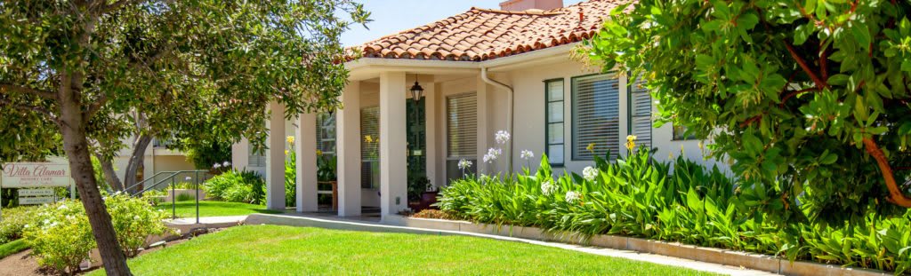 A charming house with a well-maintained garden and tiled roof.
