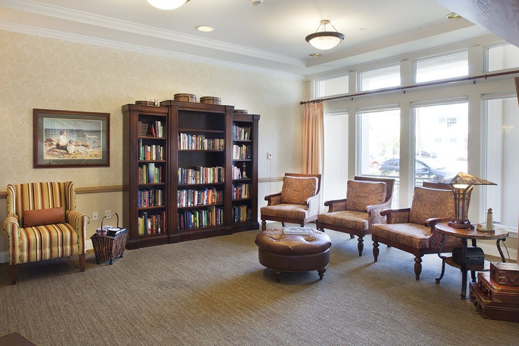 A cozy library room with bookshelves and comfortable seating.