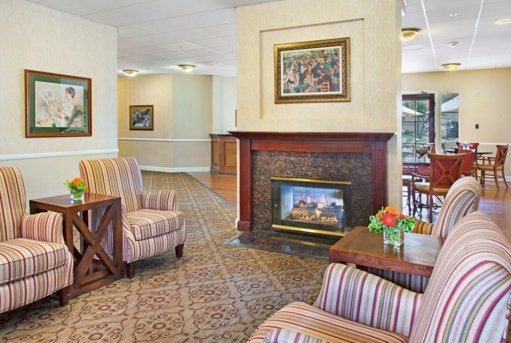 A cozy lobby with a fireplace, comfortable seating, and elegant decor.