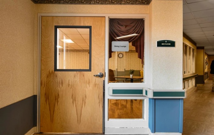 The entrance to a hospital waiting room with a door and window.