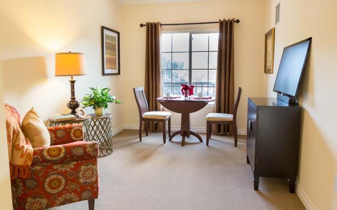 Cozy living room with a small dining area near the window.