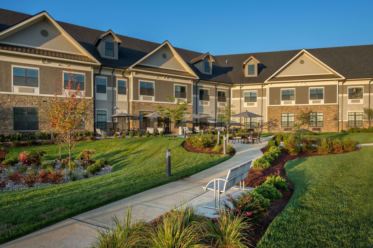 A well-maintained residential building with landscaped gardens and a walking path.