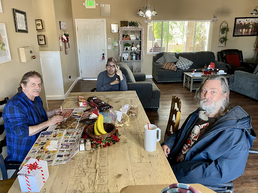 A casual gathering around the dining table, where family members engage in conversation.