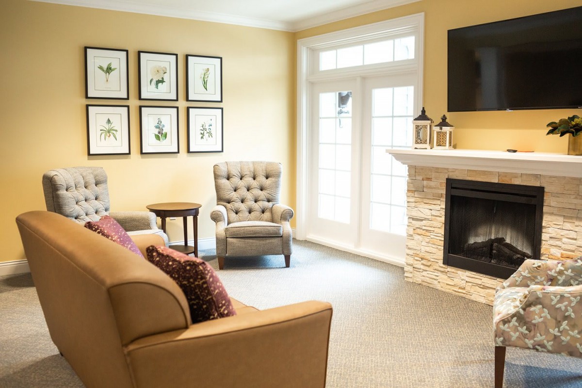 A cozy living room with comfortable seating and a modern fireplace.