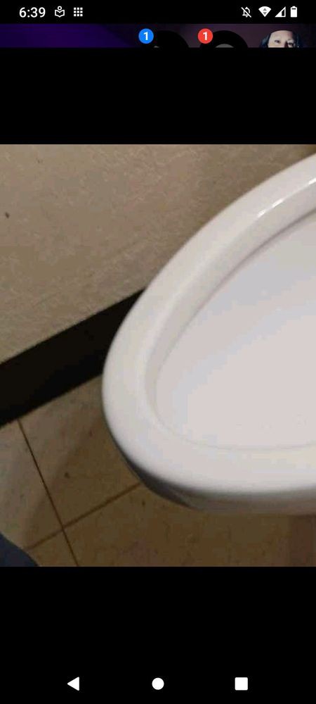 A ceramic urinal in a restroom setting.