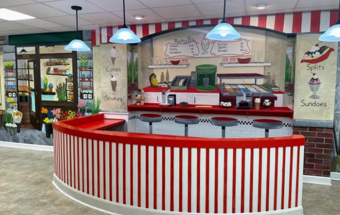 A retro diner setting with a red and white striped counter and vintage decor.