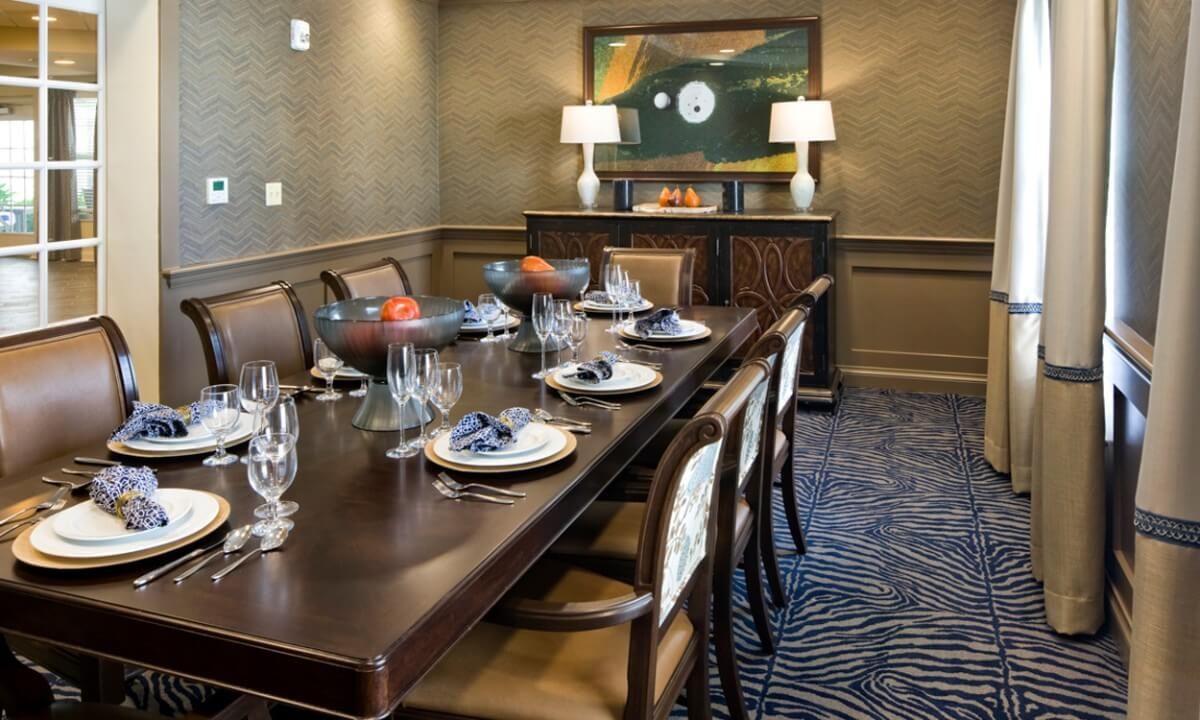 An elegantly set dining room with sophisticated decor and artwork.