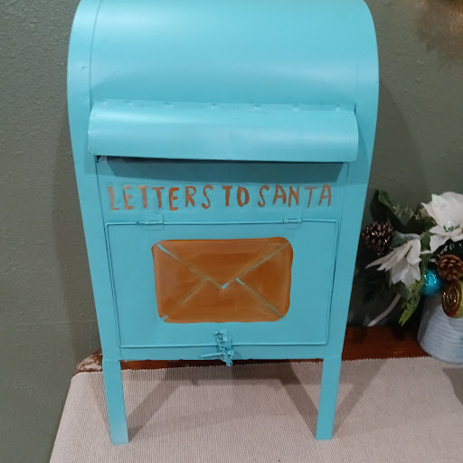 A charming blue mailbox designed for collecting letters.