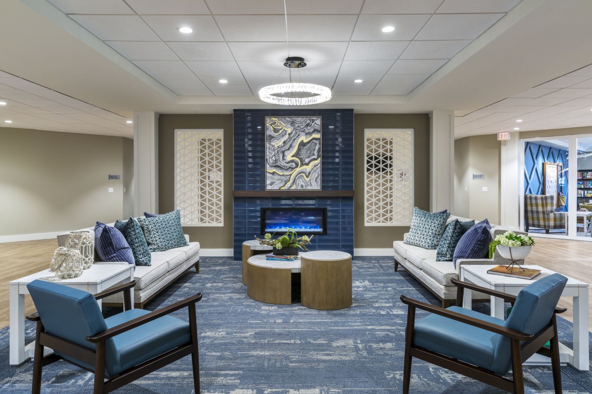A stylish modern living room featuring comfortable sofas, elegant coffee tables, and striking artwork.