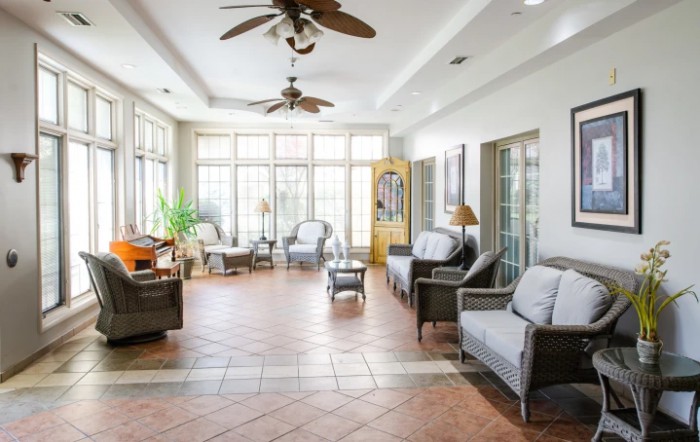 A spacious living room with abundant natural light, featuring comfortable seating and elegant decor.