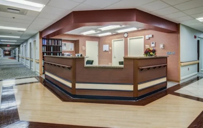 A view of a modern reception area with a central desk and office decor.