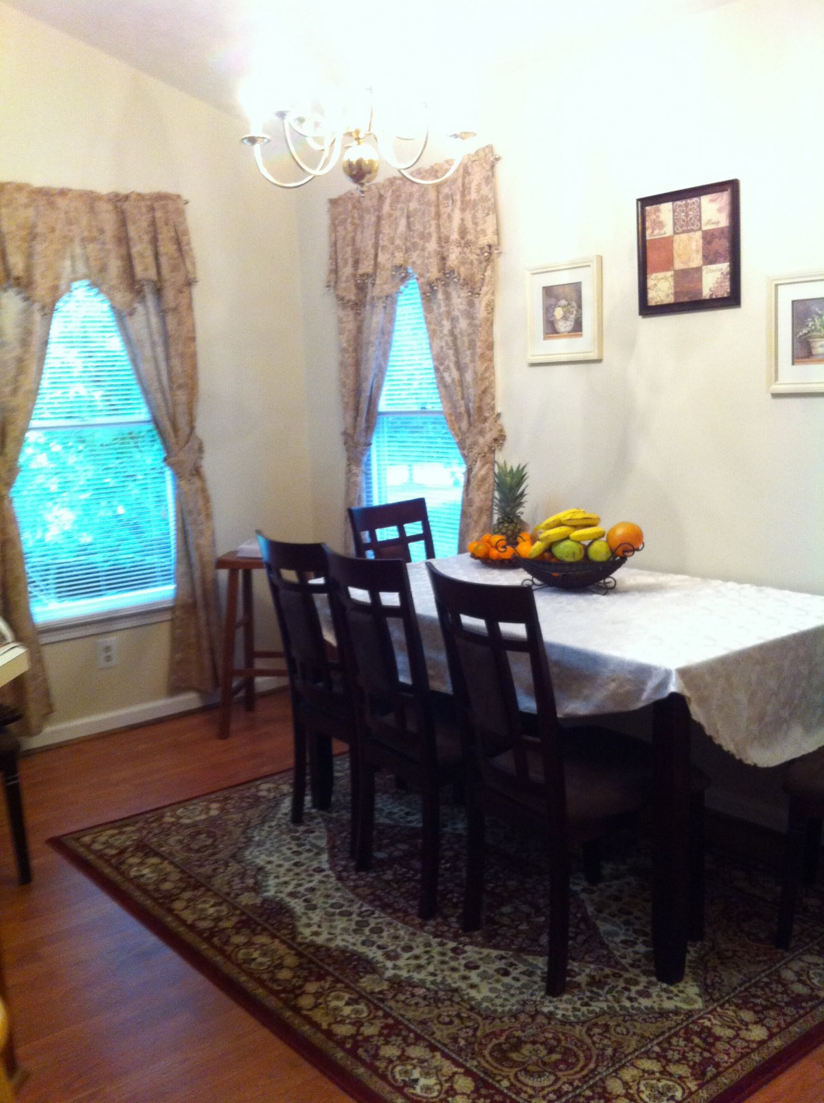 A cozy dining room with a set table and decorative elements.
