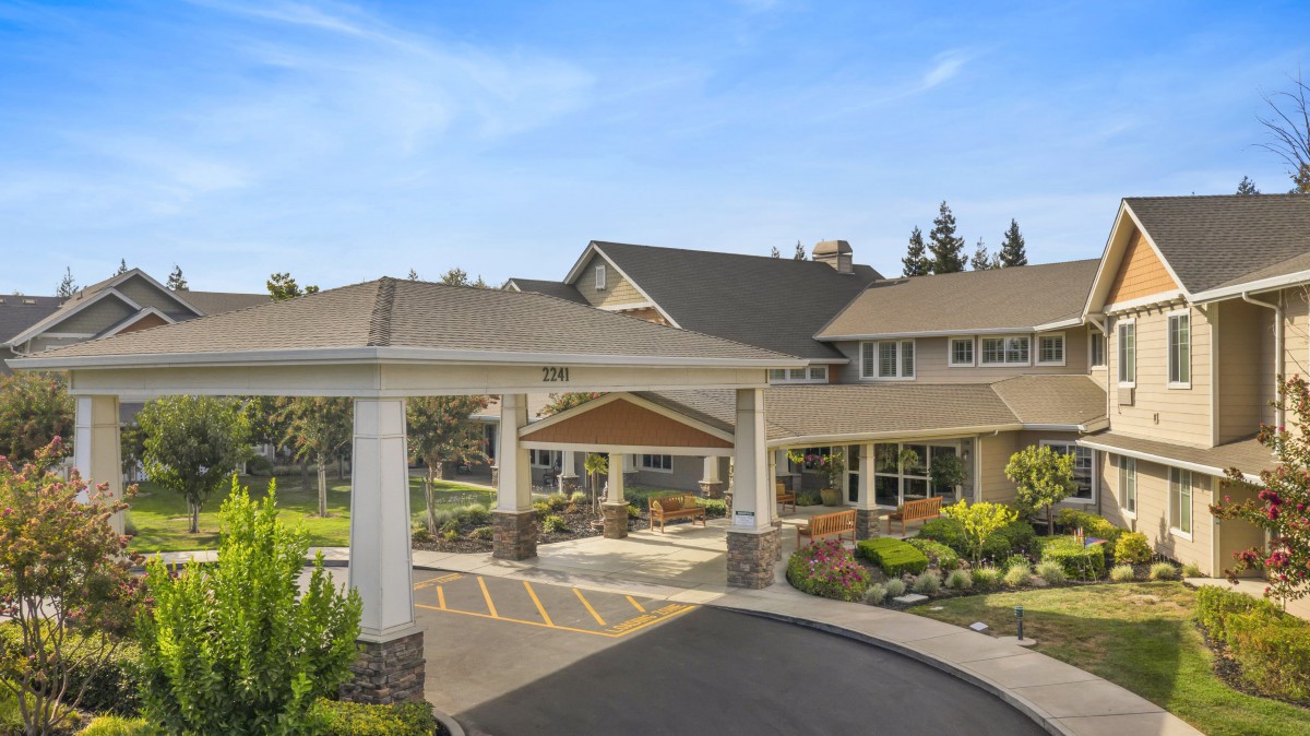 A modern building with a welcoming entrance and landscaped surroundings.