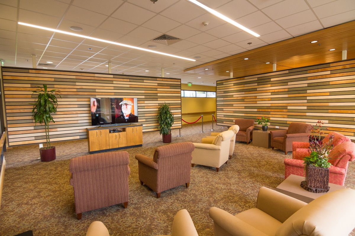 A modern lounge area with comfortable seating and a television.