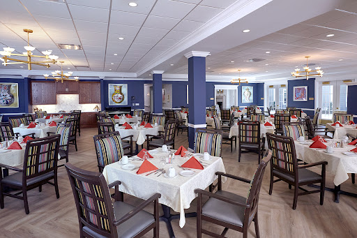 A beautifully set dining area ready for guests, featuring elegant decor and ample seating.