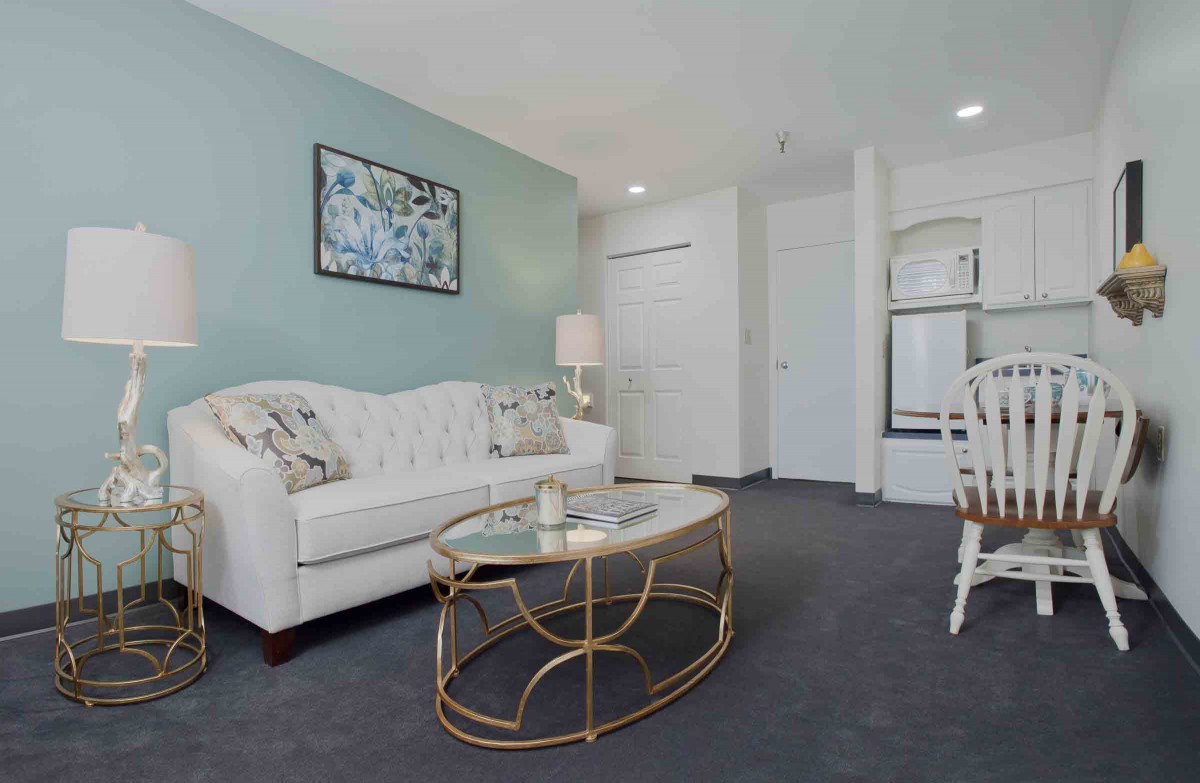 A modern living room with a white sofa, stylish coffee table, and decorative elements.