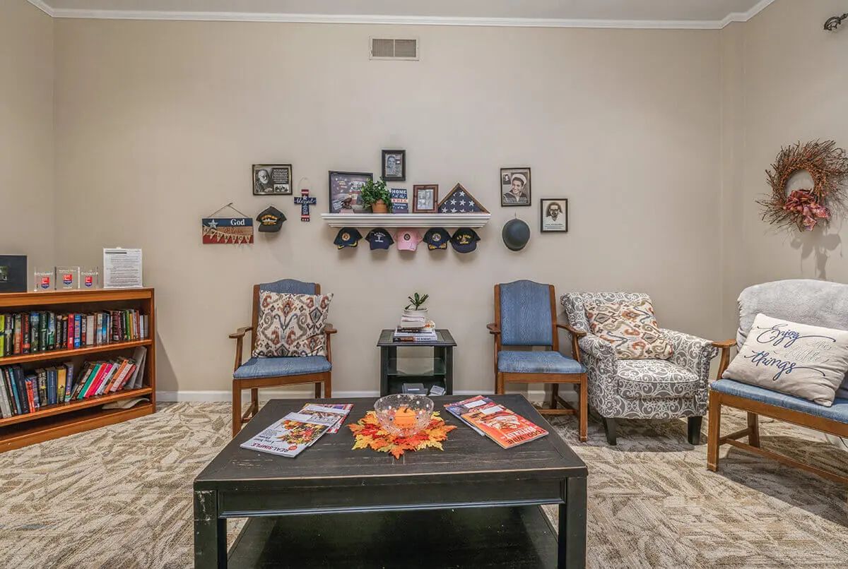 A cozy living room with decorated walls and comfortable seating.