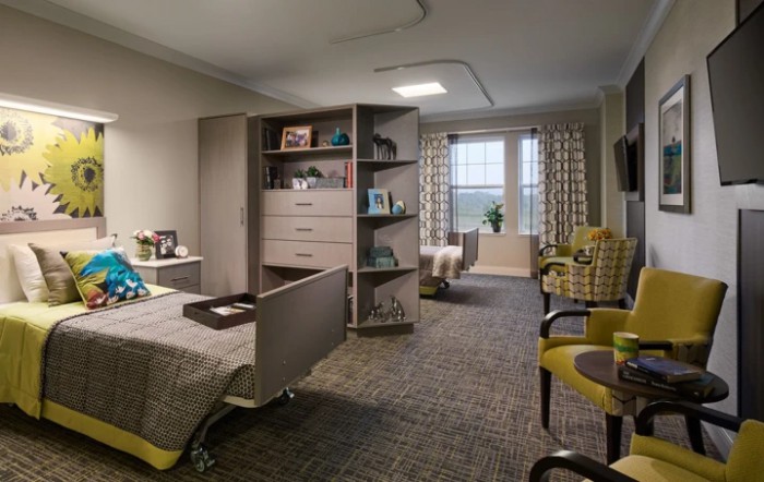 A cozy and well-decorated bedroom with modern furniture and a large window.