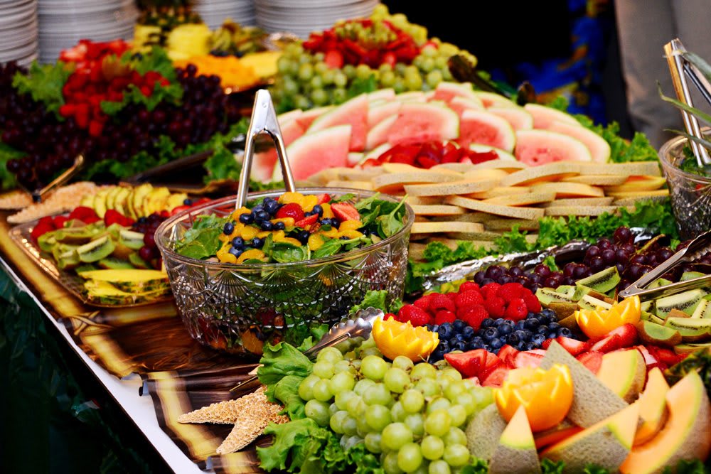A colorful assortment of fruits arranged on a buffet table.