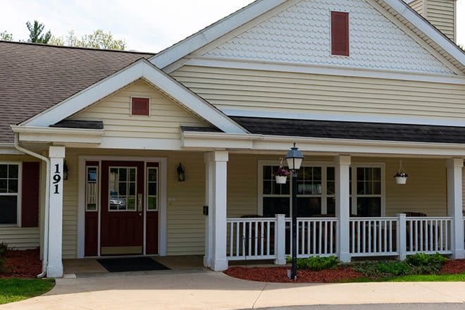 A residential building with a front porch and entrance.