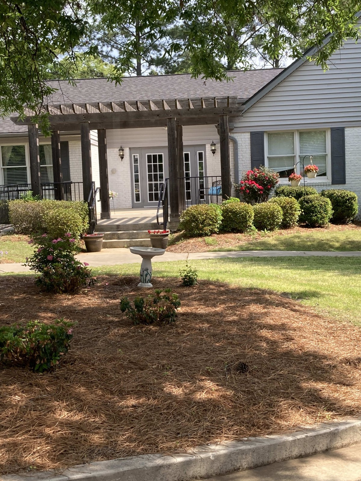 A charming house with a well-maintained garden and front porch.
