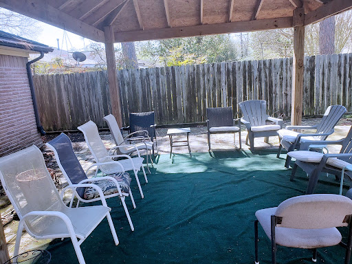 A spacious outdoor seating area under a canopy, perfect for relaxation and gatherings.