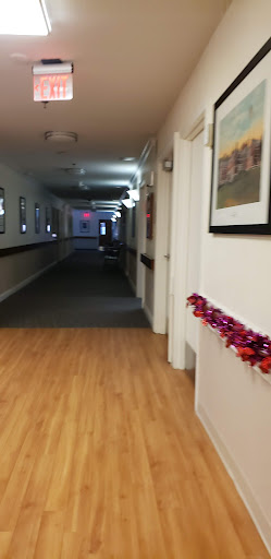 A decorated hallway featuring vibrant artwork and soft lighting.