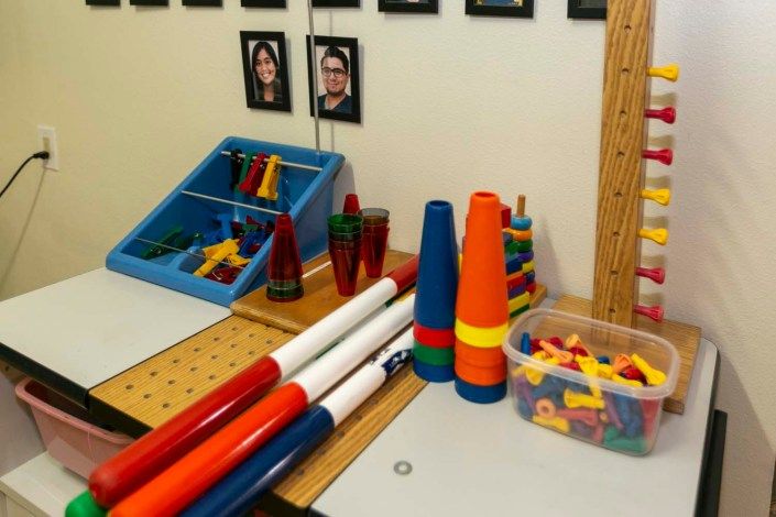 A collection of juggling equipment and colorful stacking toys arranged indoors.