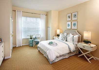 A cozy and elegantly designed bedroom with neutral tones and stylish decor.