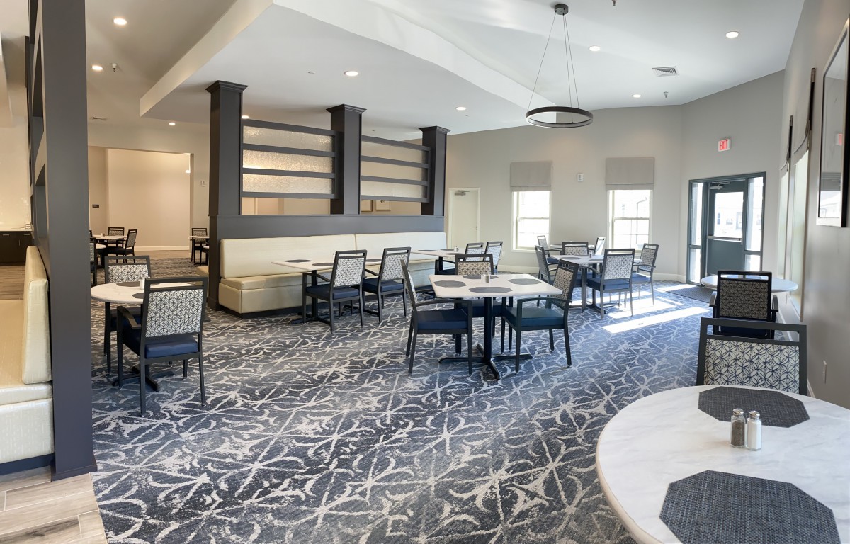 A modern dining area with tables, chairs, and elegant decor.