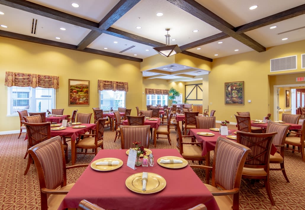 A well-lit, elegantly designed restaurant dining area with neatly arranged tables and chairs.