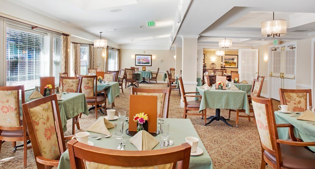 An elegant dining area with neatly arranged tables and chairs, ready for guests.