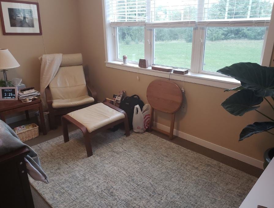 A cozy living room corner with a chair by the window.