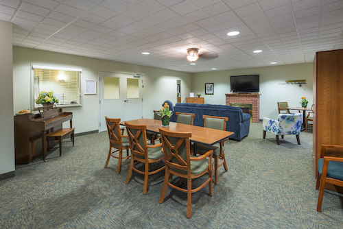 A cozy lounge and dining area featuring wooden furniture and a comfortable sofa.