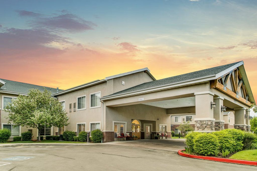 A hotel building at sunset with a welcoming entrance.