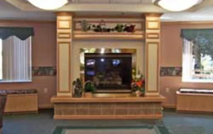 A decorative fireplace with a wooden mantelpiece in a cozy interior setting.
